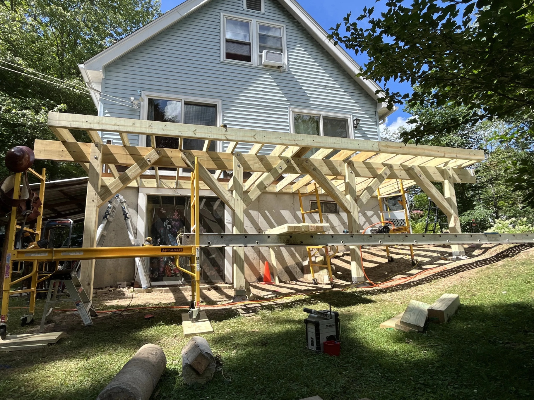 Pressure-treated framing with 6x6 posts, doubled beams, and knee bracing during the Nottingham NH deck build